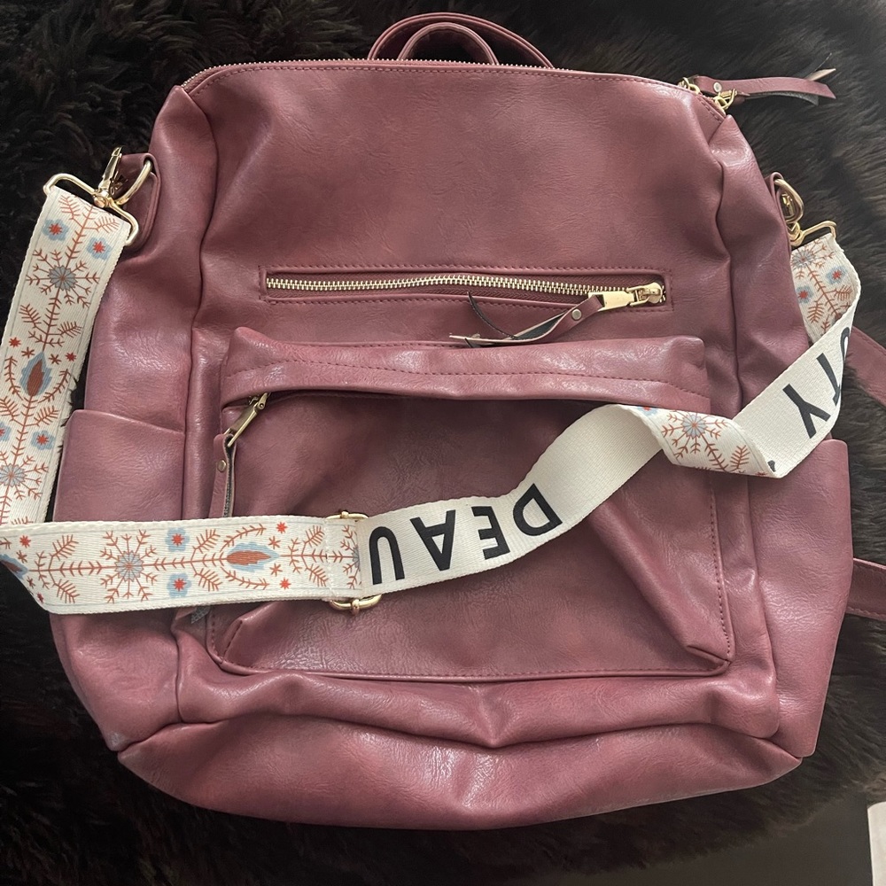Backpack! So cute and comes with a removable strap!